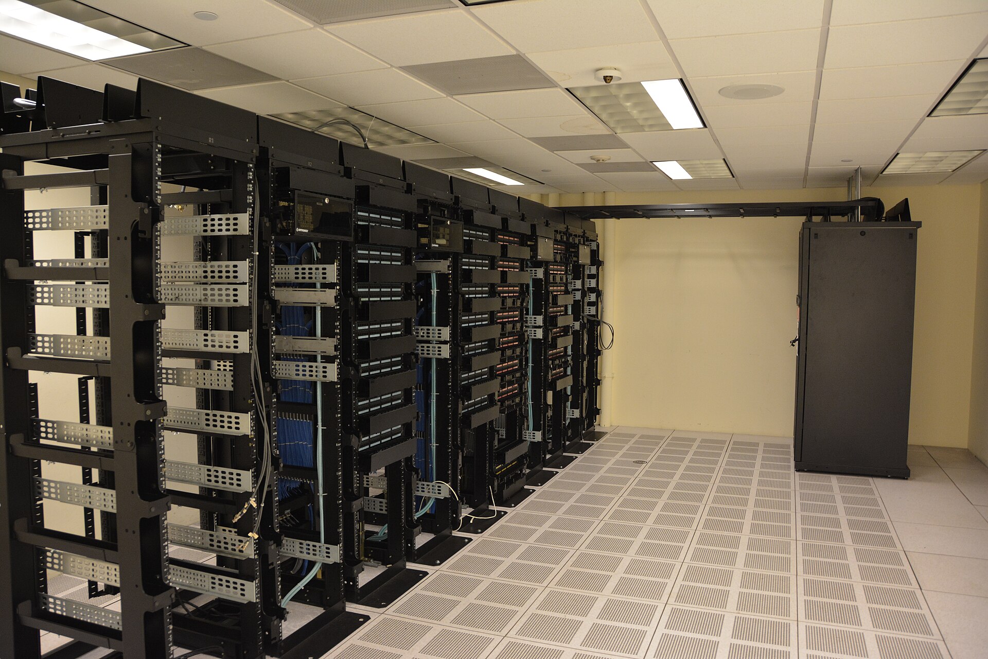 Rows of server racks in a data centre, illustrating the computing infrastructure behind AI model development