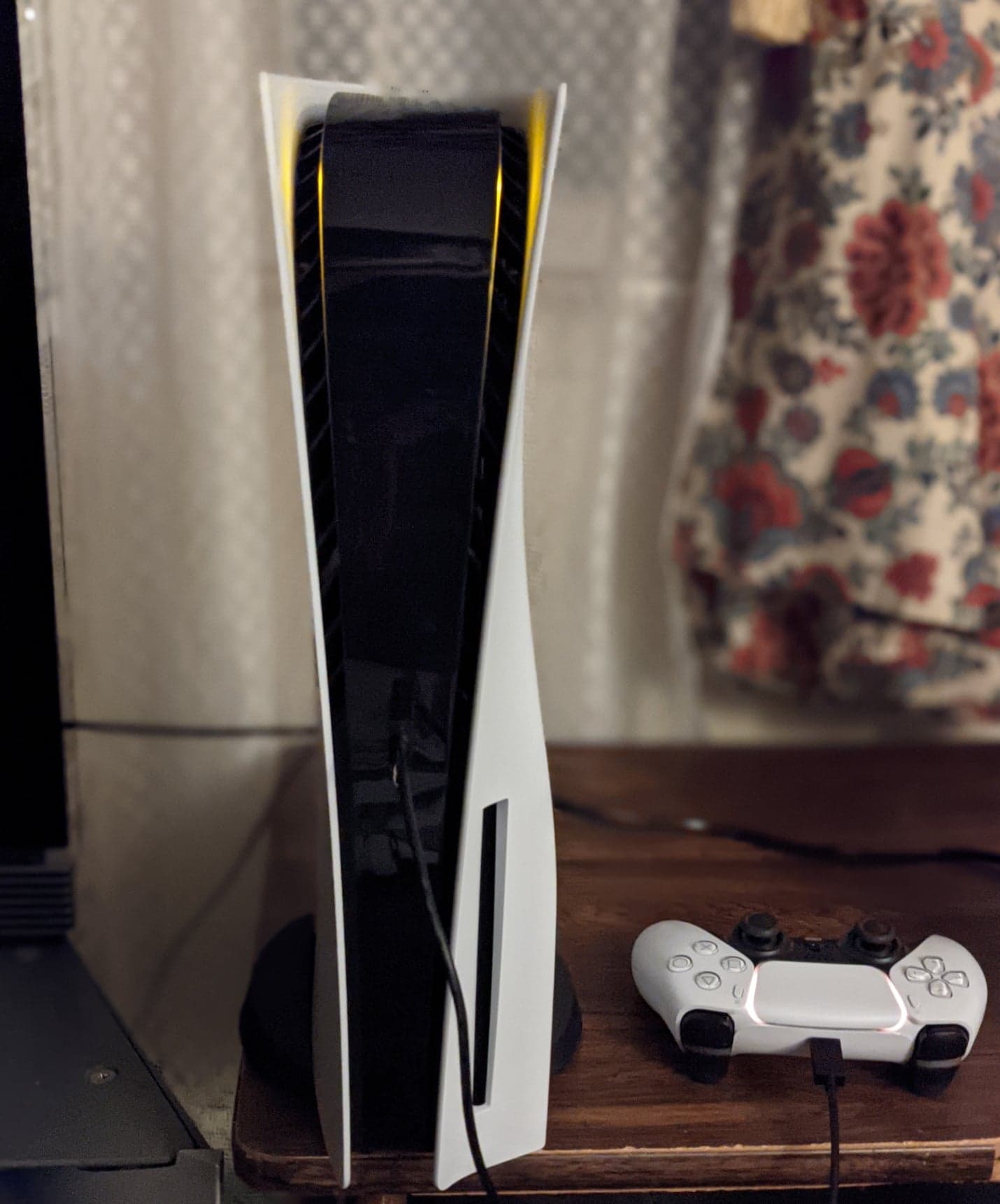 A PlayStation 5 console beside a DualSense controller