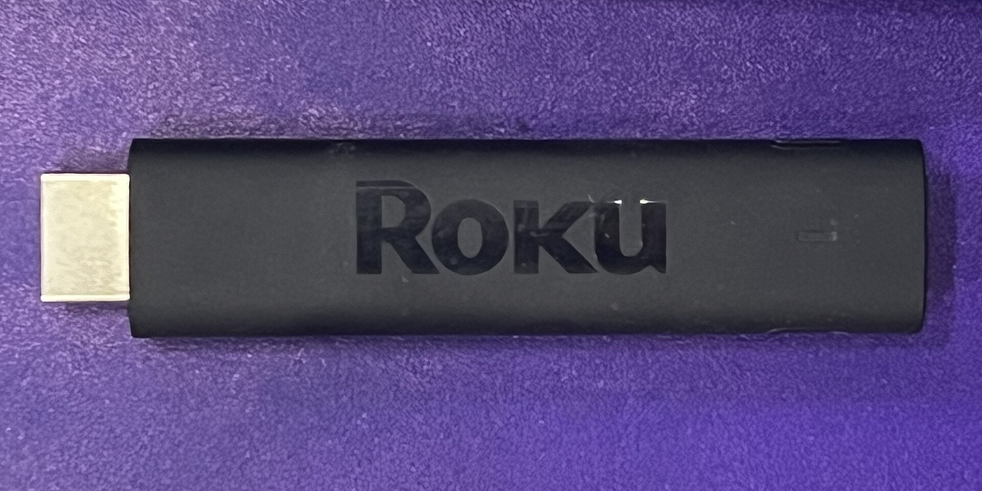 A Roku Streaming Stick 4K streaming device with its remote